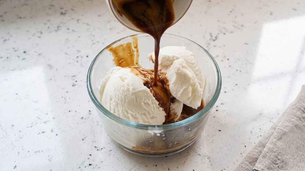 Espresso pours over gelato for affogato italy