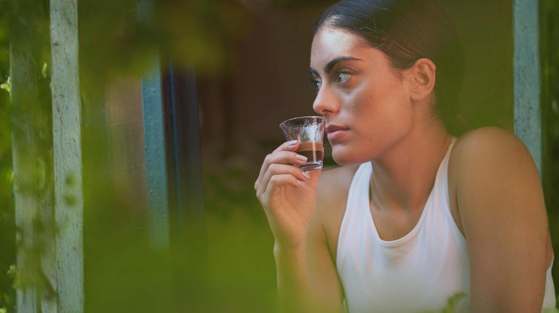 An Italian woman drinks Neapolitan Espresso