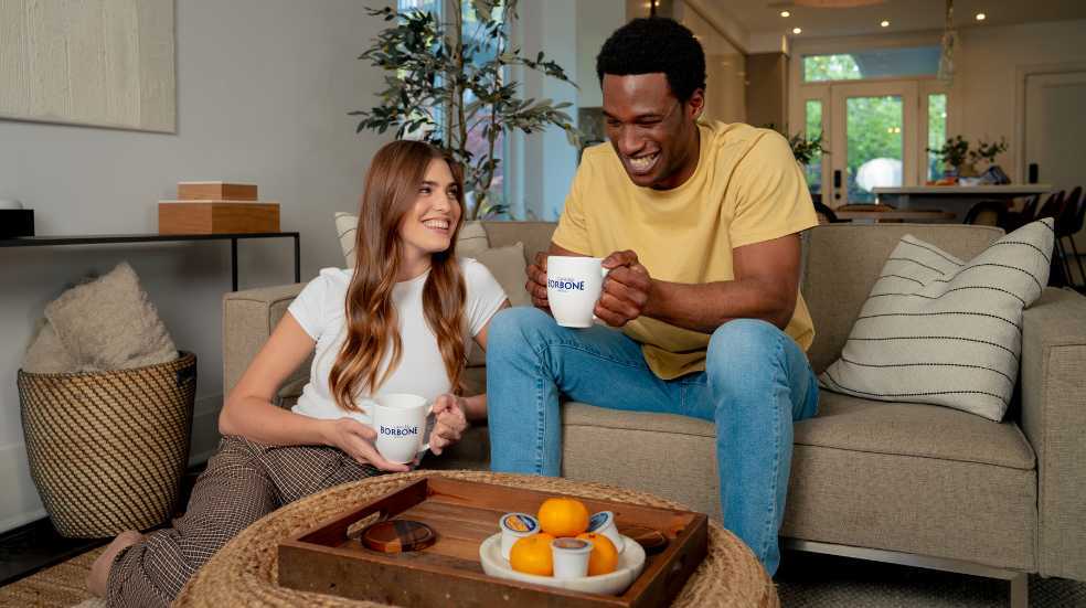 How to remove coffee stains from clothes A couple drinks coffee on a sofa - how to remove coffee stains from clothes and more